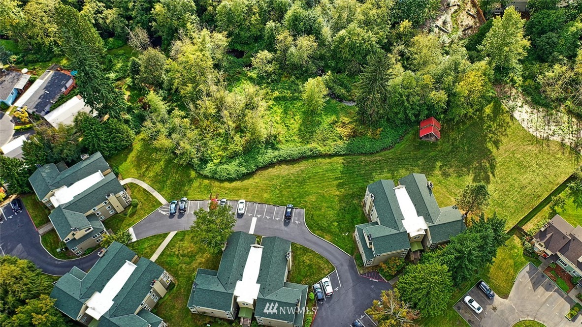 20330 Bothell Everett Highway, Unit C204 Bothell, WA 98012 - Photo 17 of 24 an aerial view of a house with outdoor space and trees all around