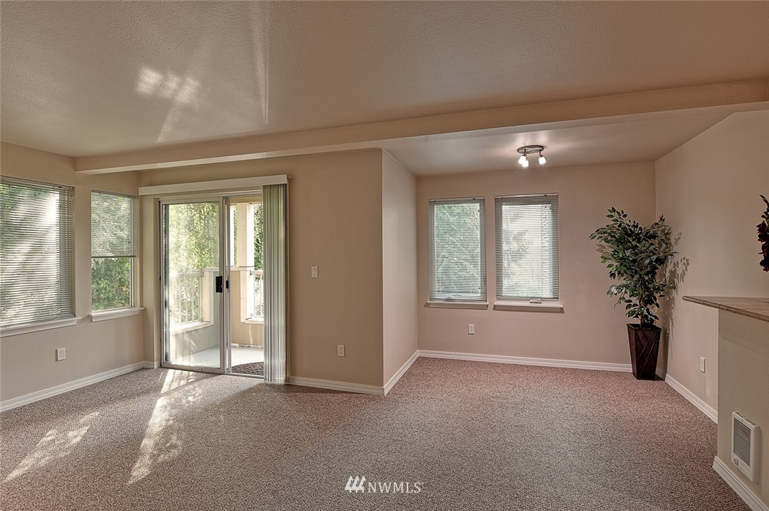 20330 Bothell Everett Highway, Unit C204 Bothell, WA 98012 - Photo 5 of 24 a view of livingroom with window and front door