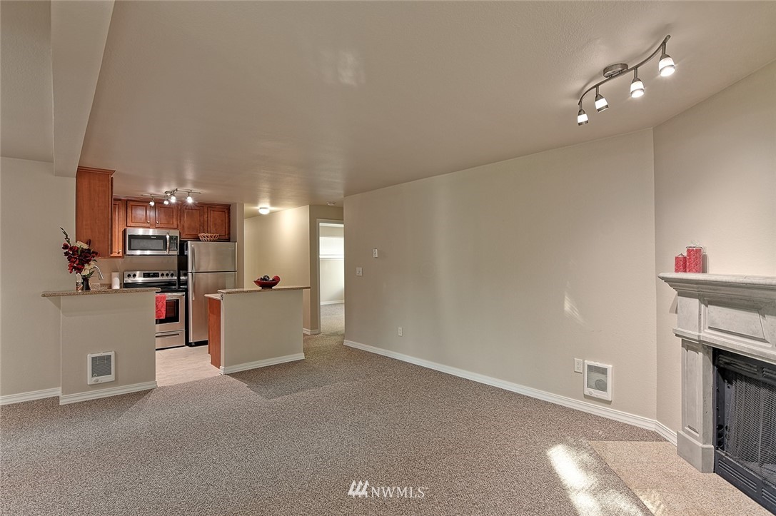 20330 Bothell Everett Highway, Unit C204 Bothell, WA 98012 - Photo 8 of 24 a view of kitchen and living room