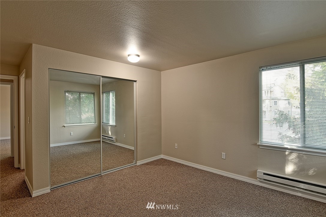 20330 Bothell Everett Highway, Unit C204 Bothell, WA 98012 - Photo 9 of 24 an empty room with sliding glass door
