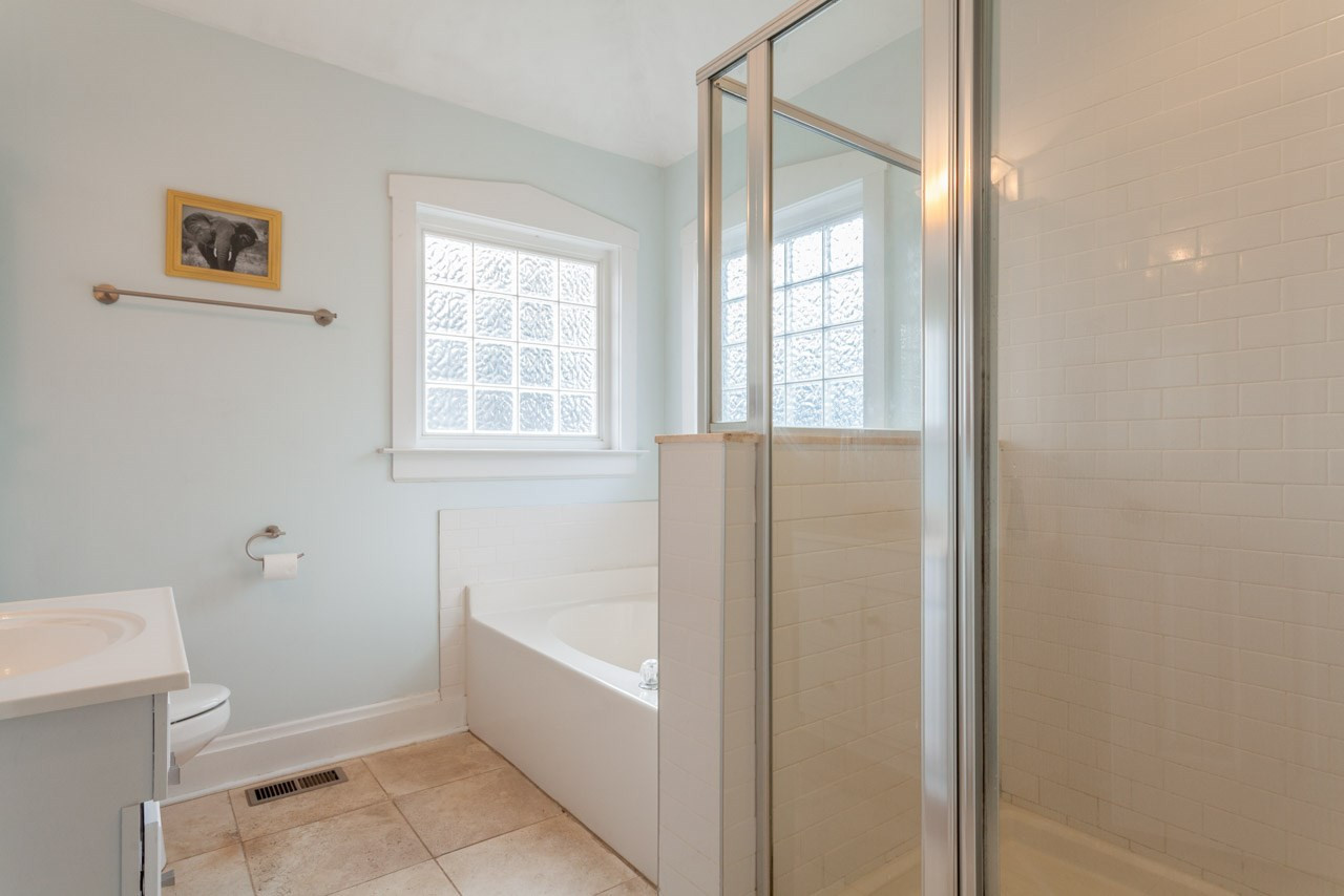 500 Frank Street Raleigh, NC 27604 - Photo 16 of 23 While the tiled master bath features a soaking tub as well as a glass doored shower.
