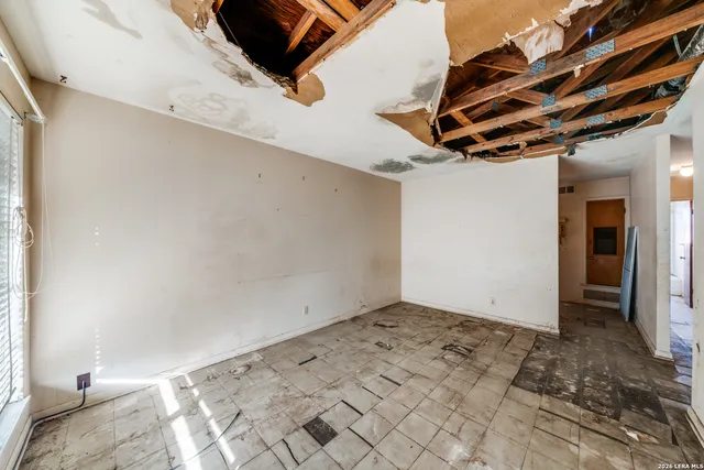 a view of an empty room with windows