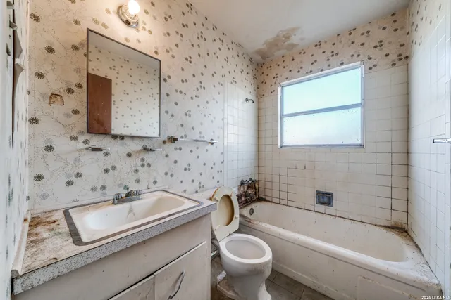 a bathroom with a sink toilet and bathtub