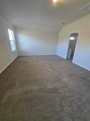 a picture of a room with a bench and white walls