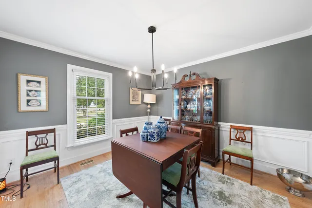 a bathroom with a sink a mirror a toilet and a window