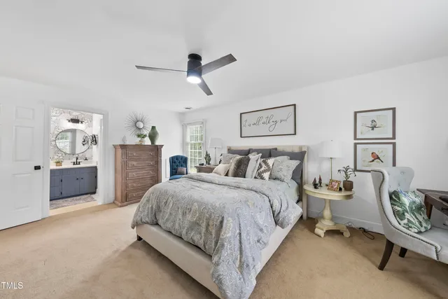 a spacious bedroom with a bed a couch and a window