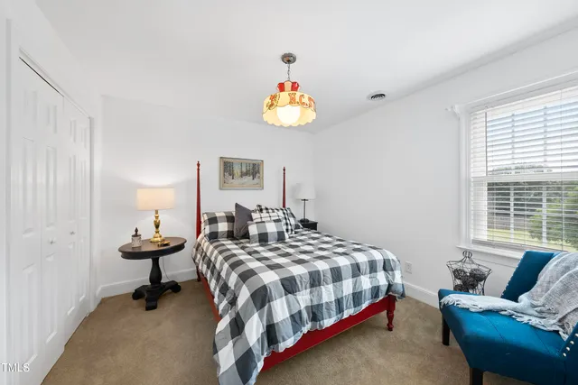 a bathroom with a sink and mirror with bathtub