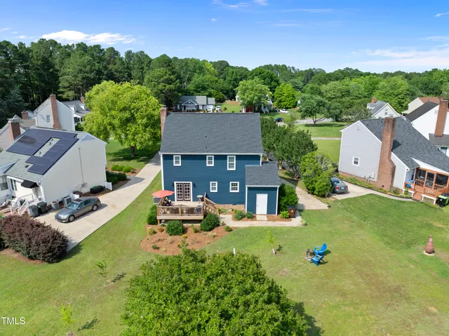 a swimming pool with outdoor seating and yard
