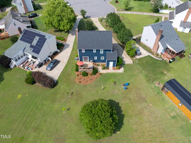 an aerial view of a house with swimming pool garden and patio