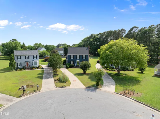 a aerial view of a house with outdoor space tennis court