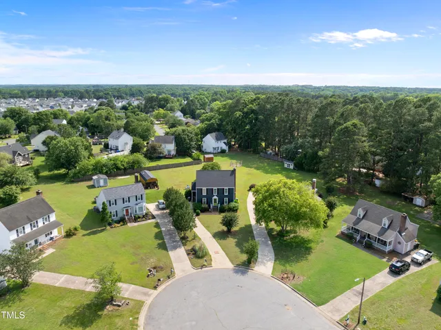 an aerial view of a house with swimming pool garden and lake view