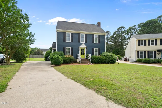 a front view of house with yard and green space