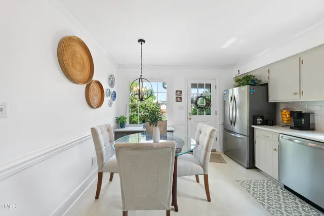 a kitchen with stainless steel appliances granite countertop a sink stove refrigerator and cabinets