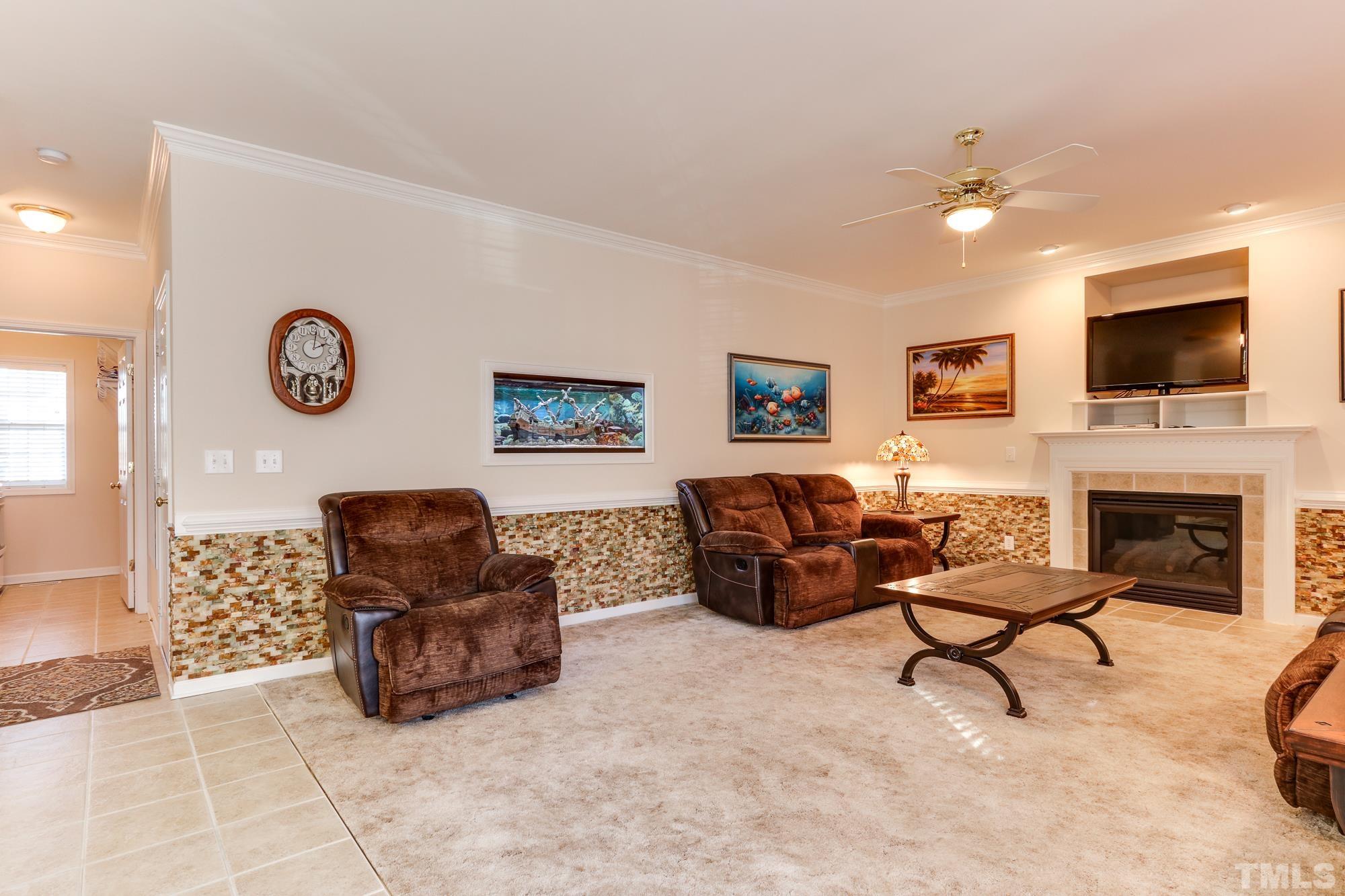 100 Mickleson Ridge Drive Raleigh, NC 27603 - Photo 12 of 59 a living room with furniture and a flat screen tv