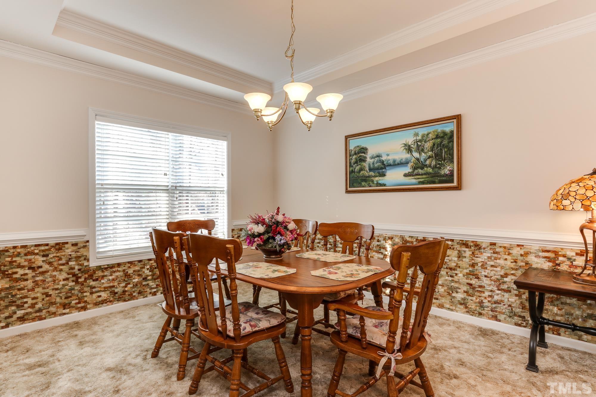 100 Mickleson Ridge Drive Raleigh, NC 27603 - Photo 18 of 59 a view of a dining room with furniture window and outside view