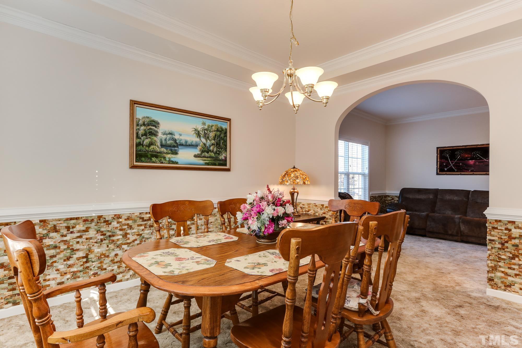 100 Mickleson Ridge Drive Raleigh, NC 27603 - Photo 19 of 59 a view of a dining room with furniture and chandelier