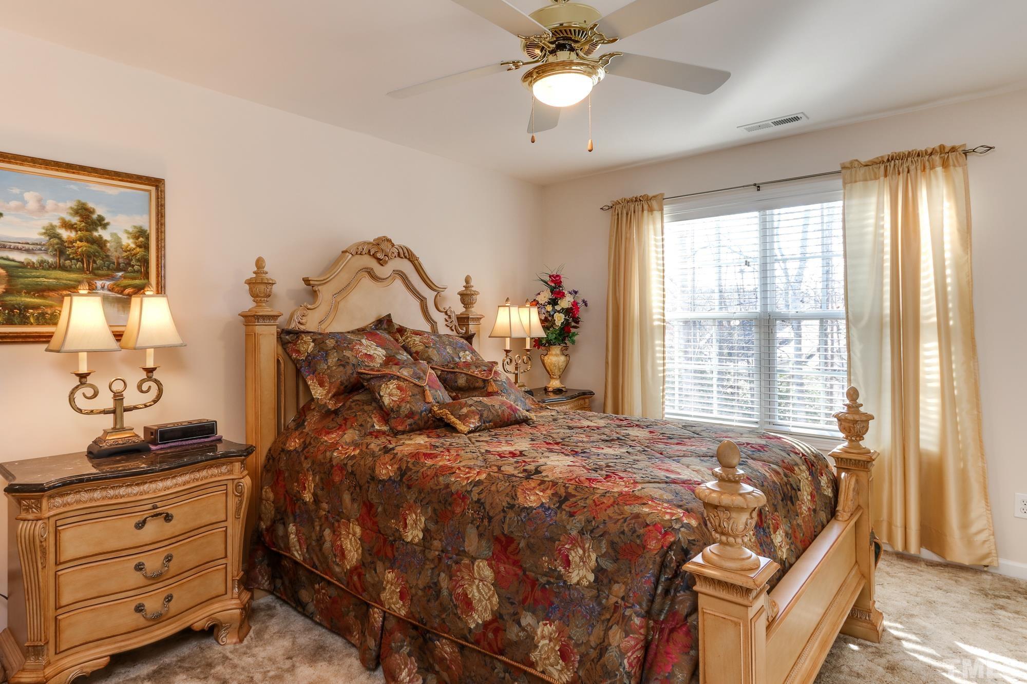 100 Mickleson Ridge Drive Raleigh, NC 27603 - Photo 28 of 59 a bed sitting in a bedroom next to a window