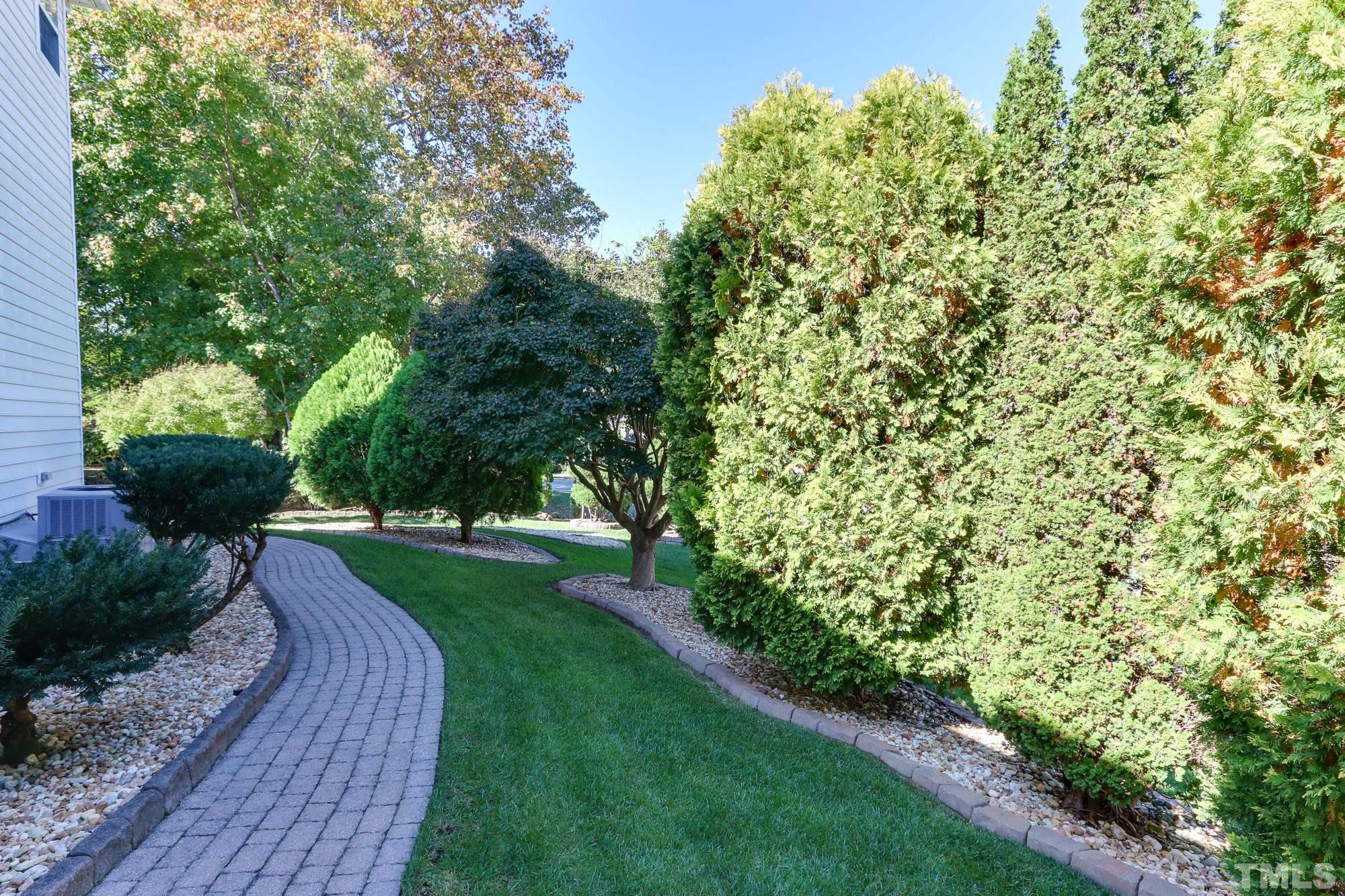 100 Mickleson Ridge Drive Raleigh, NC 27603 - Photo 44 of 59 a view of a backyard with potted plants and large trees