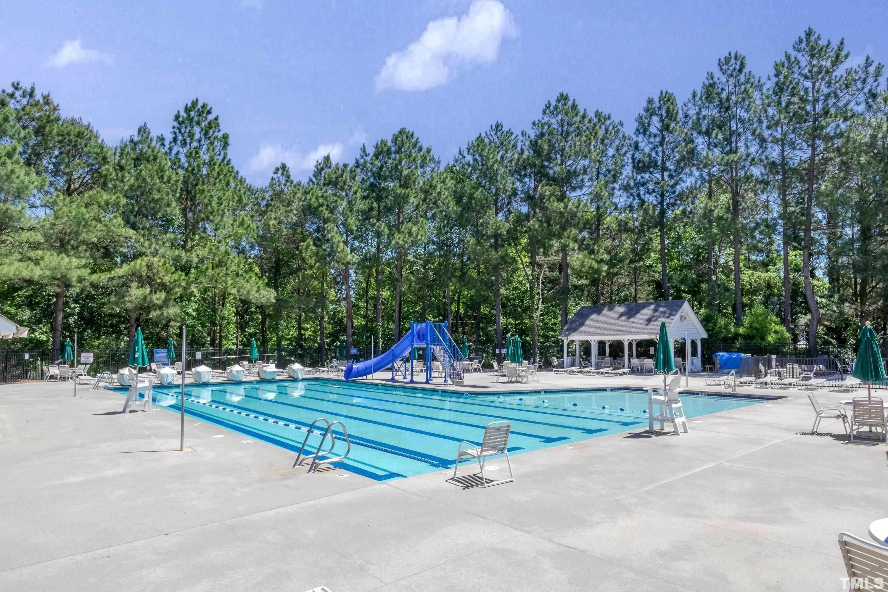 100 Mickleson Ridge Drive Raleigh, NC 27603 - Photo 54 of 59 a swimming pool with outdoor seating and yard in the back