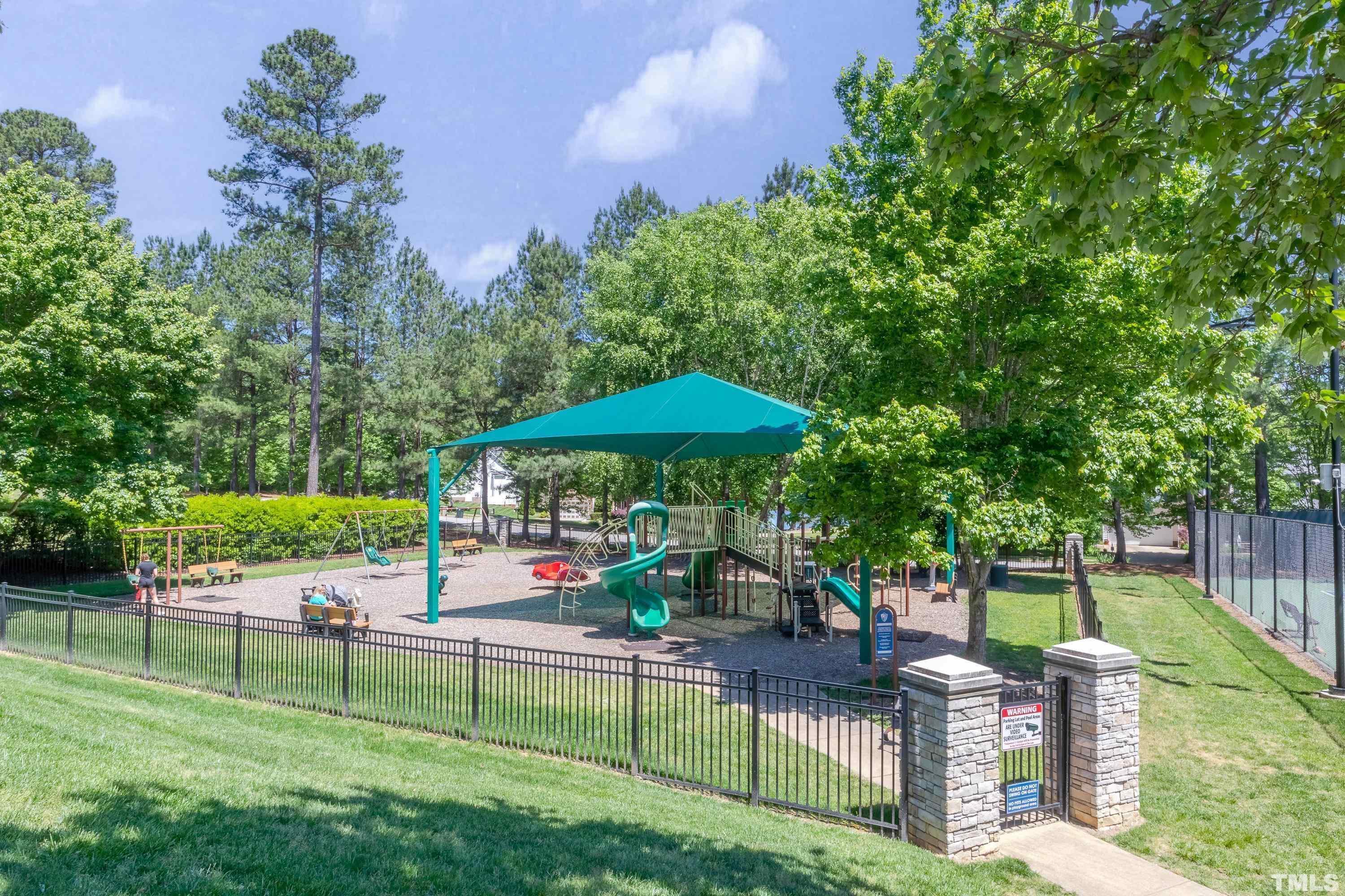 100 Mickleson Ridge Drive Raleigh, NC 27603 - Photo 58 of 59 a view of a table and chairs under an umbrella