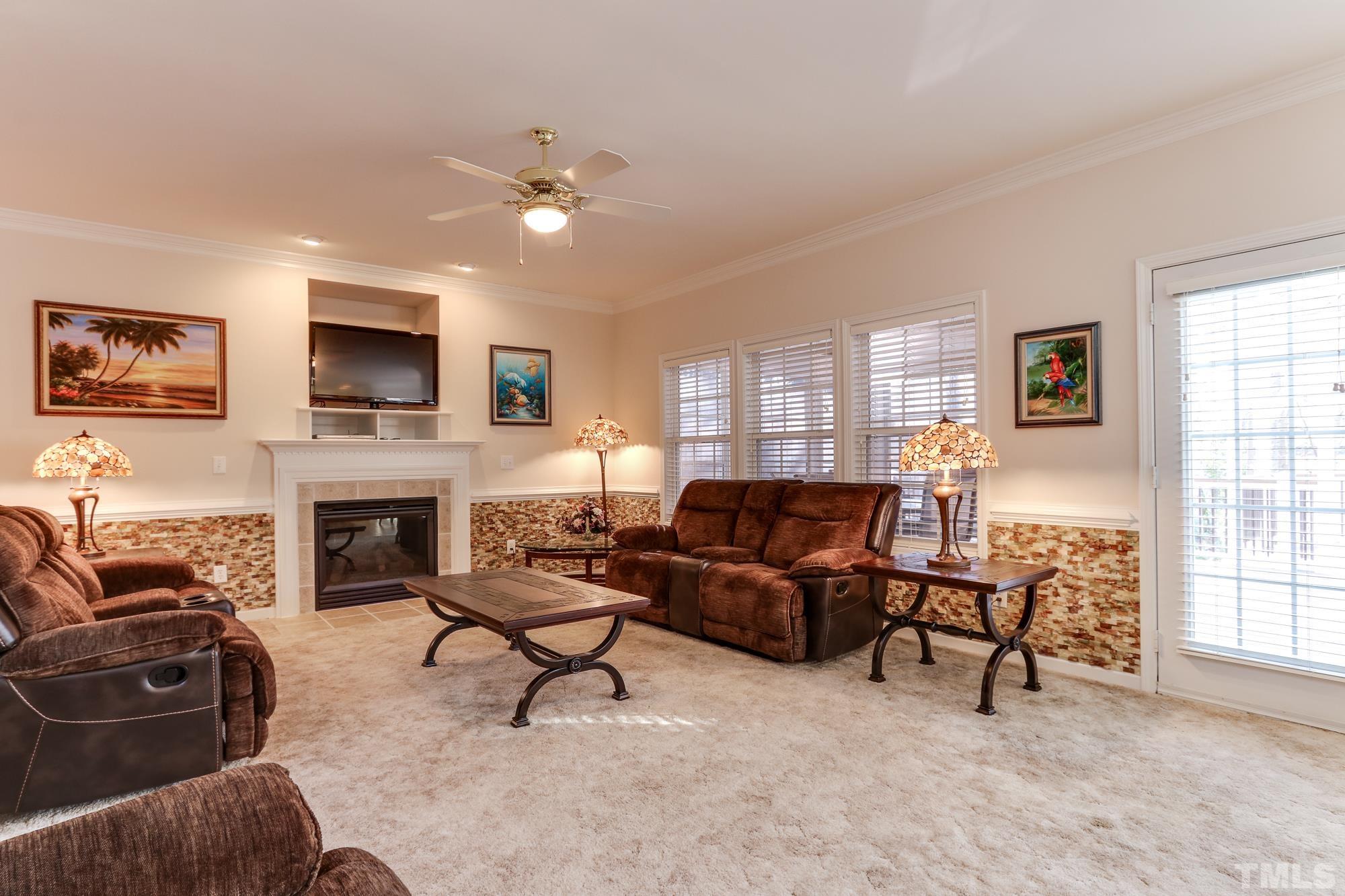 100 Mickleson Ridge Drive Raleigh, NC 27603 - Photo 10 of 59 a living room with furniture a fireplace and a flat screen tv