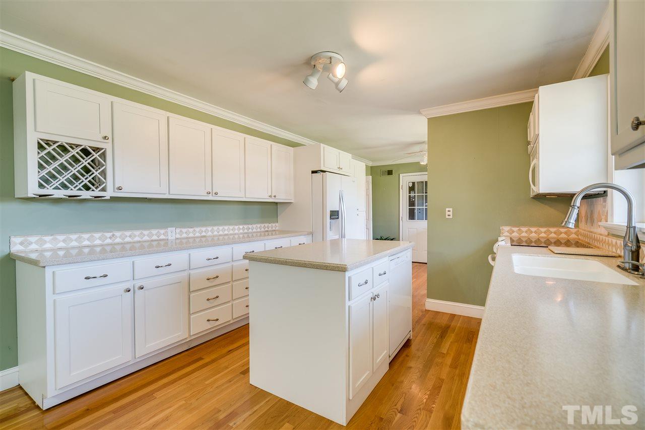 959 Lawson Chapel Church Road Roxboro, NC 27574 - Photo 11 of 25 a kitchen with granite countertop a sink and cabinets
