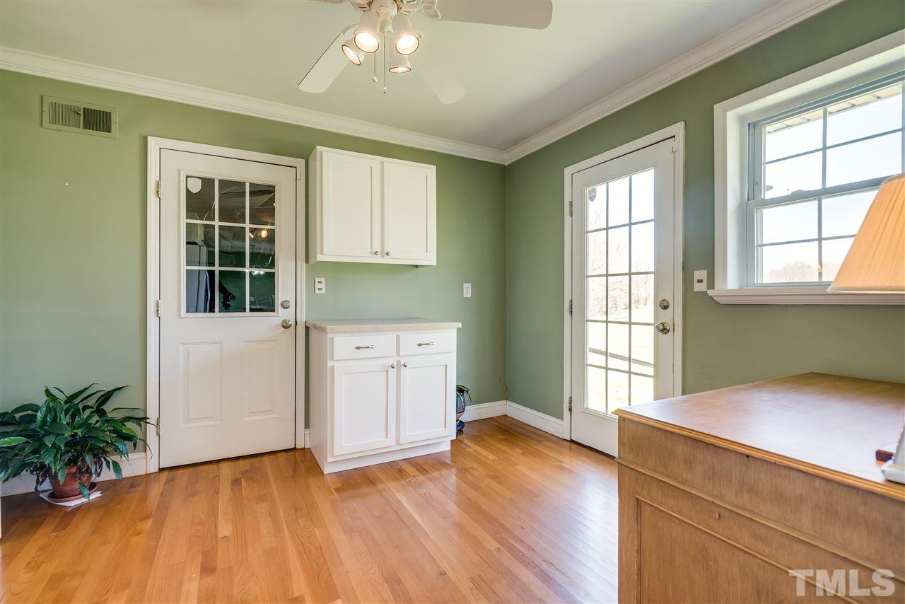 959 Lawson Chapel Church Road Roxboro, NC 27574 - Photo 12 of 25 an empty room with wooden floor and windows