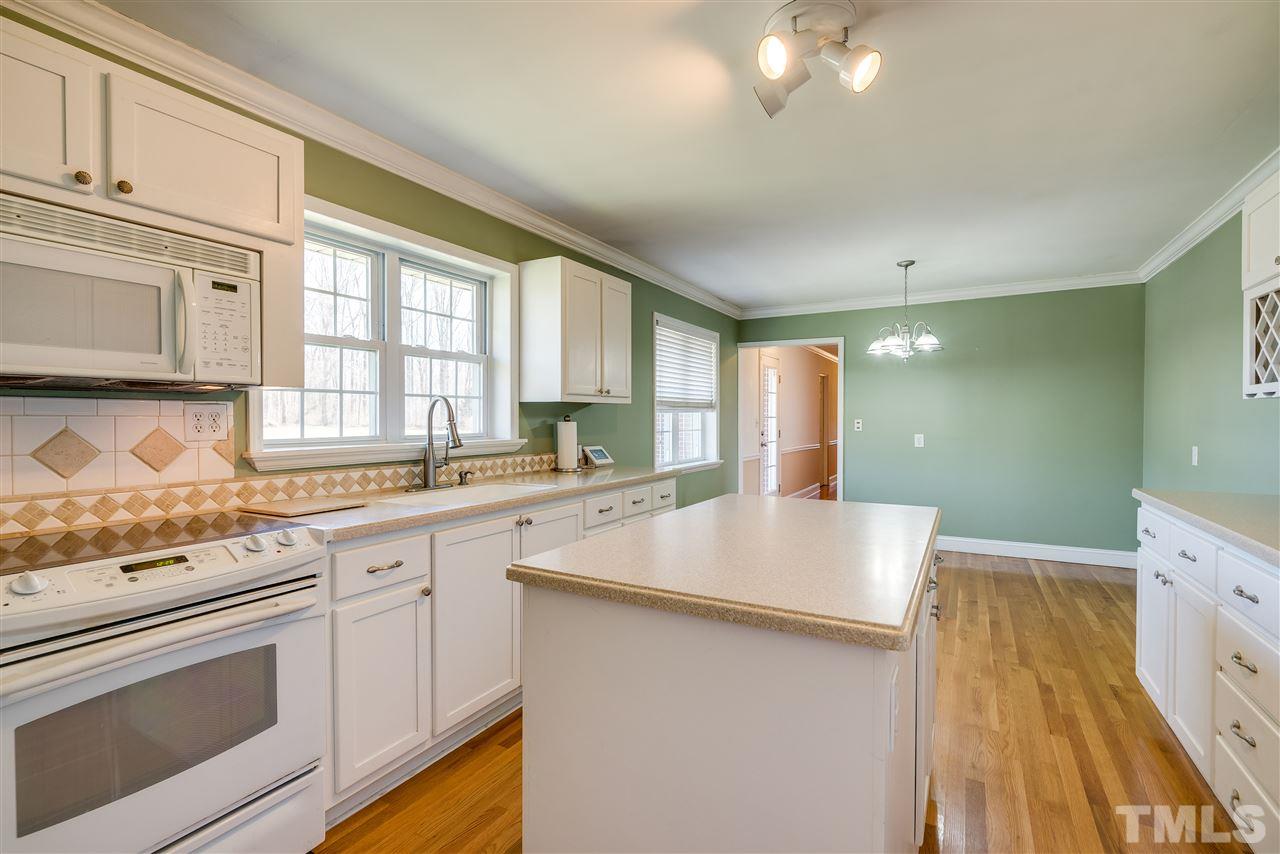 959 Lawson Chapel Church Road Roxboro, NC 27574 - Photo 13 of 25 a kitchen with a sink stove and cabinets