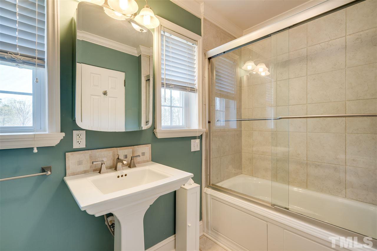 959 Lawson Chapel Church Road Roxboro, NC 27574 - Photo 15 of 25 a bathroom with a sink a toilet and a mirror