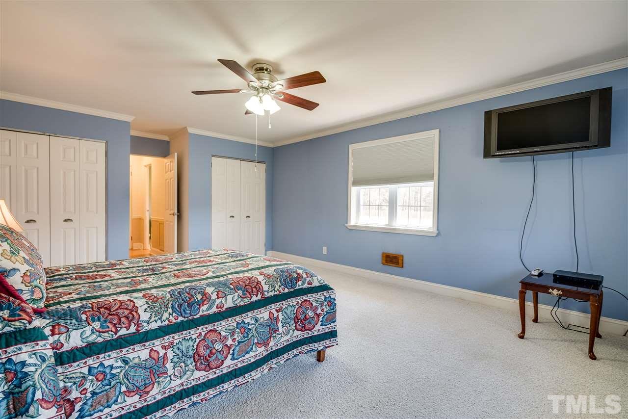 959 Lawson Chapel Church Road Roxboro, NC 27574 - Photo 17 of 25 a bedroom with a bed and a flat screen tv