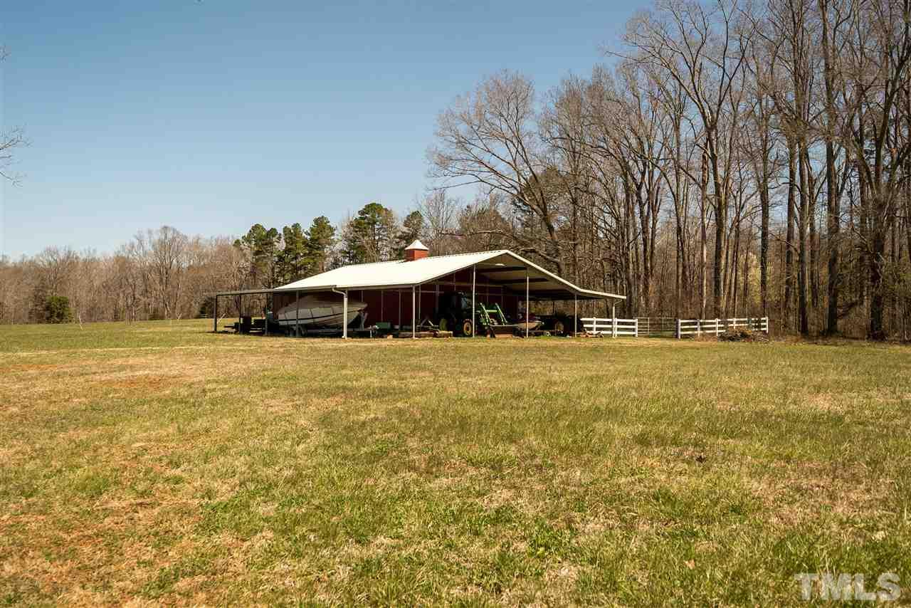 959 Lawson Chapel Church Road Roxboro, NC 27574 - Photo 19 of 25 a view of a house with pool and a yard
