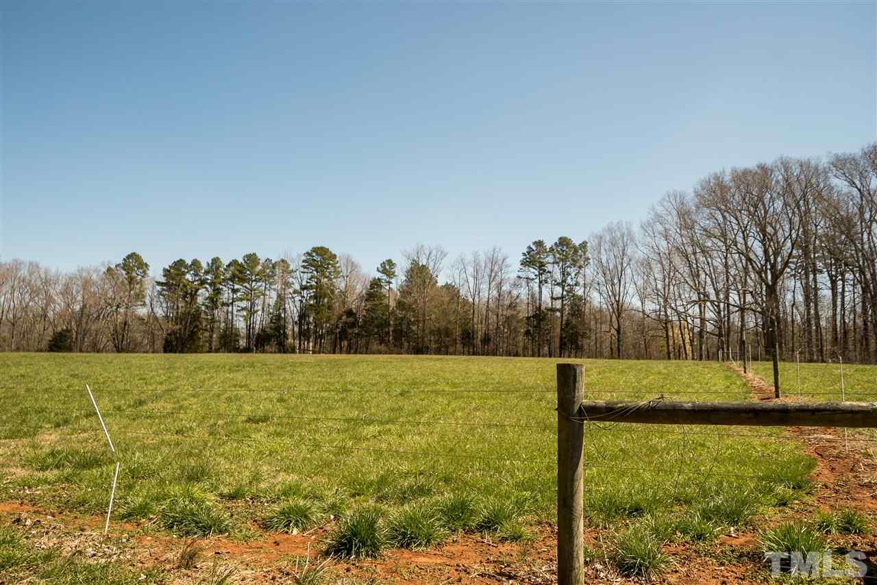959 Lawson Chapel Church Road Roxboro, NC 27574 - Photo 21 of 25 a view of a field with trees in the background
