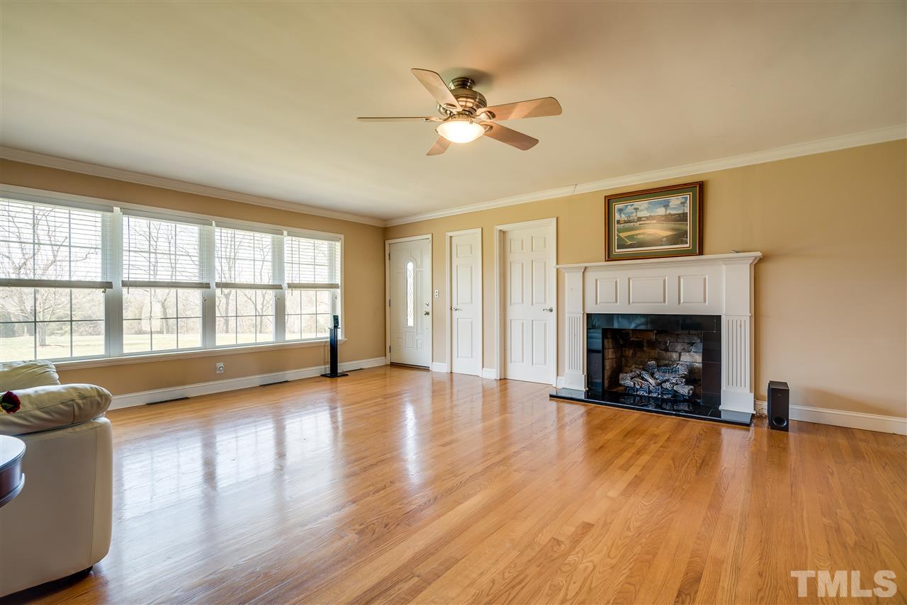 959 Lawson Chapel Church Road Roxboro, NC 27574 - Photo 5 of 25 a view of a livingroom with wooden floor and a fireplace