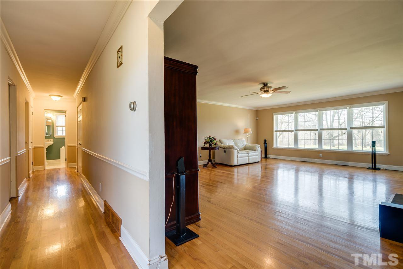 959 Lawson Chapel Church Road Roxboro, NC 27574 - Photo 7 of 25 a view of a hallway view with dining room and wooden floor