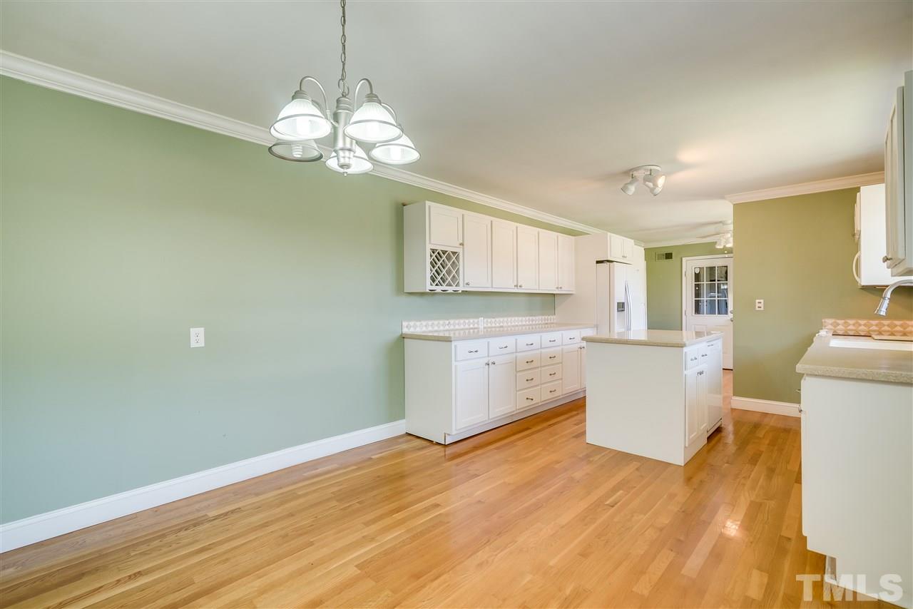 959 Lawson Chapel Church Road Roxboro, NC 27574 - Photo 8 of 25 a room with a white cabinets and chandelier