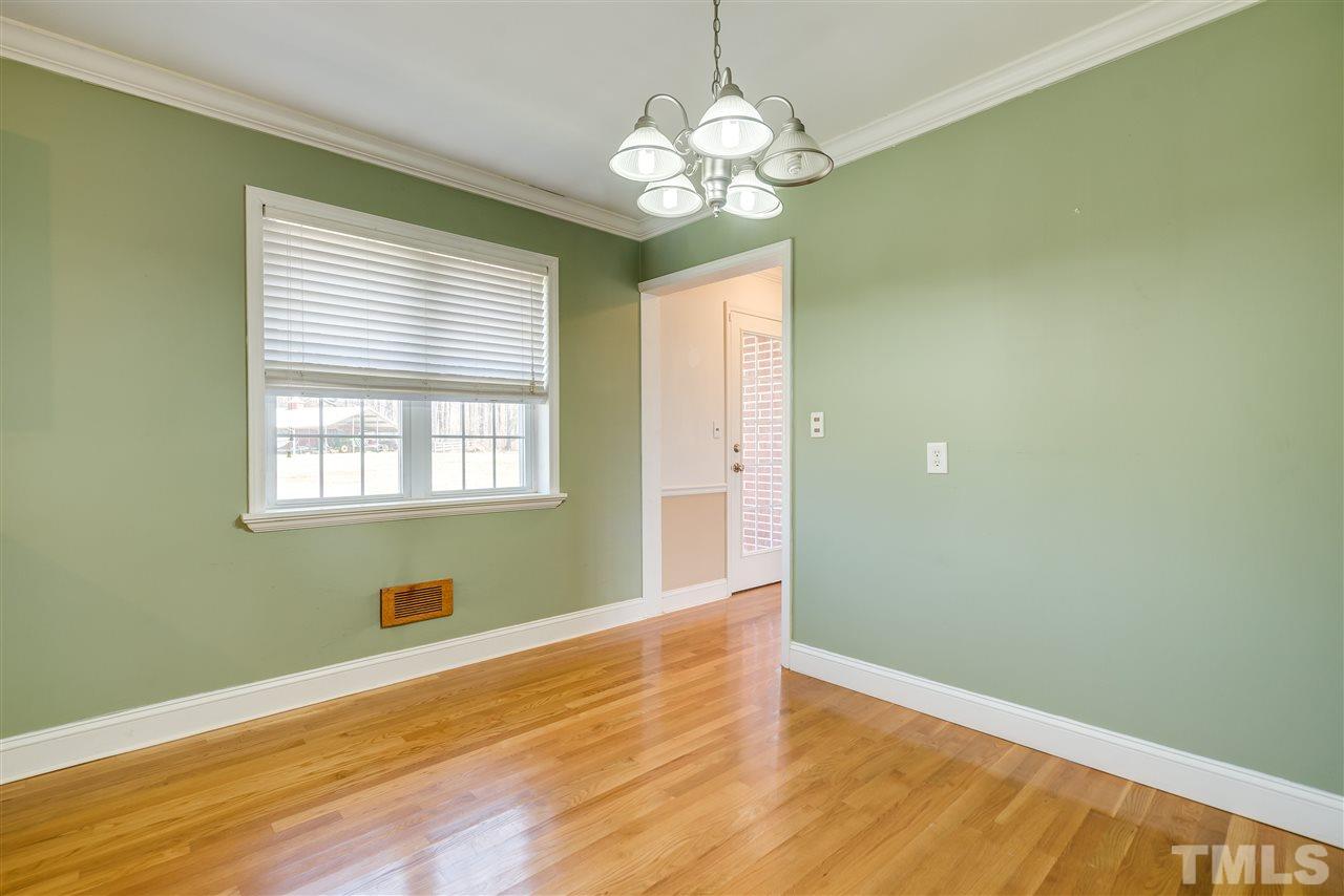 959 Lawson Chapel Church Road Roxboro, NC 27574 - Photo 9 of 25 a view of empty room with wooden floor and fan