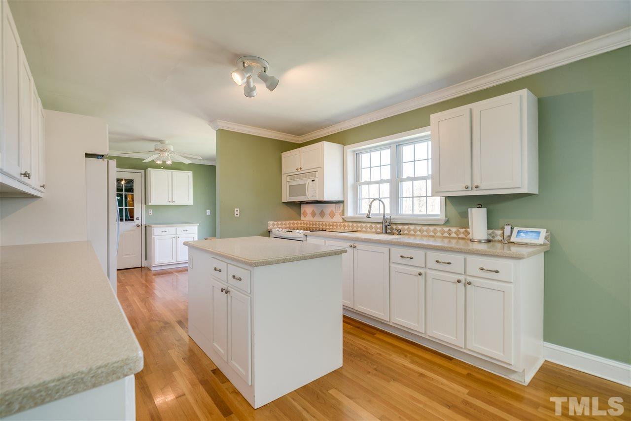 959 Lawson Chapel Church Road Roxboro, NC 27574 - Photo 10 of 25 a kitchen with granite countertop white cabinets and white appliances