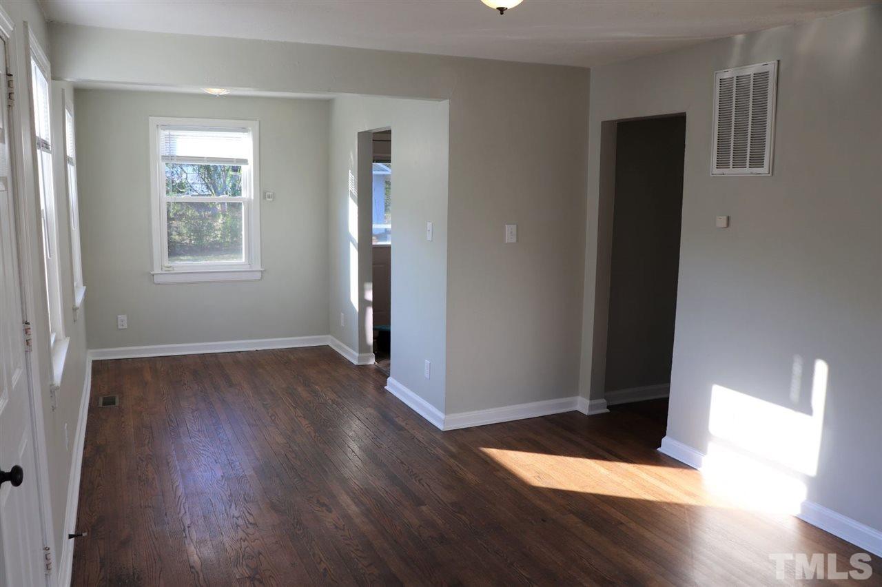 2110 Tudor Place Raleigh, NC 27610 - Photo 4 of 17 an empty room with wooden floor and windows