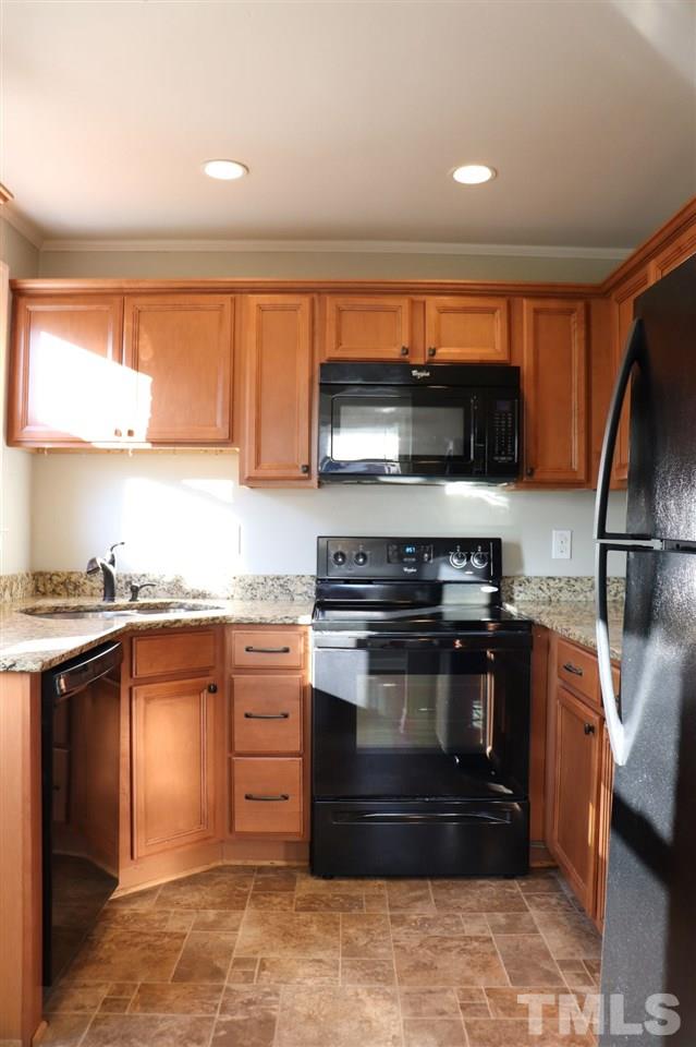 2110 Tudor Place Raleigh, NC 27610 - Photo 5 of 17 a kitchen with stainless steel appliances granite countertop a stove and a refrigerator