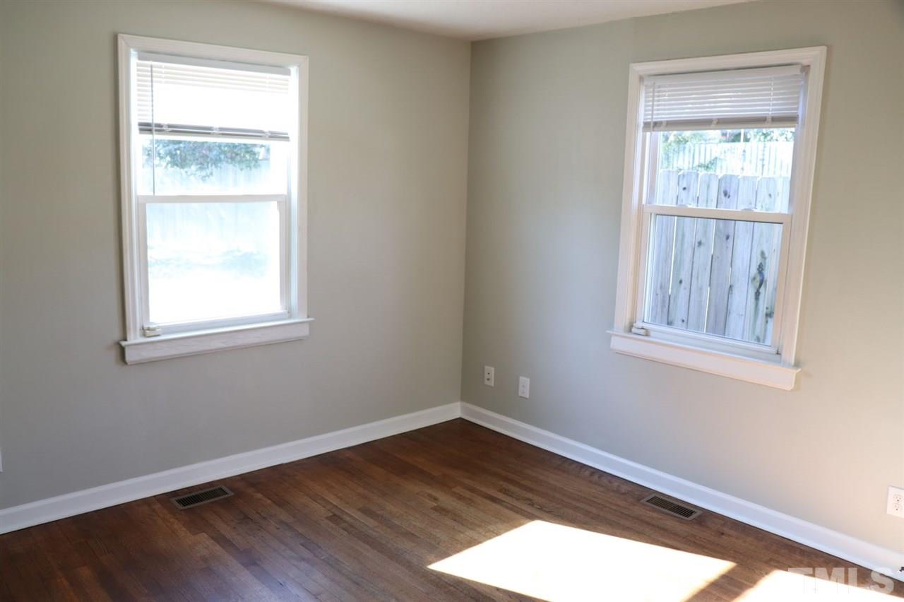 2110 Tudor Place Raleigh, NC 27610 - Photo 6 of 17 a view of an empty room with wooden floor and a window