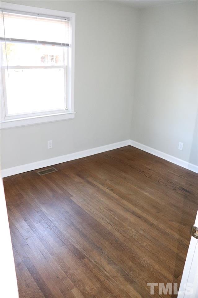 2110 Tudor Place Raleigh, NC 27610 - Photo 8 of 17 an empty room with wooden floor and a window