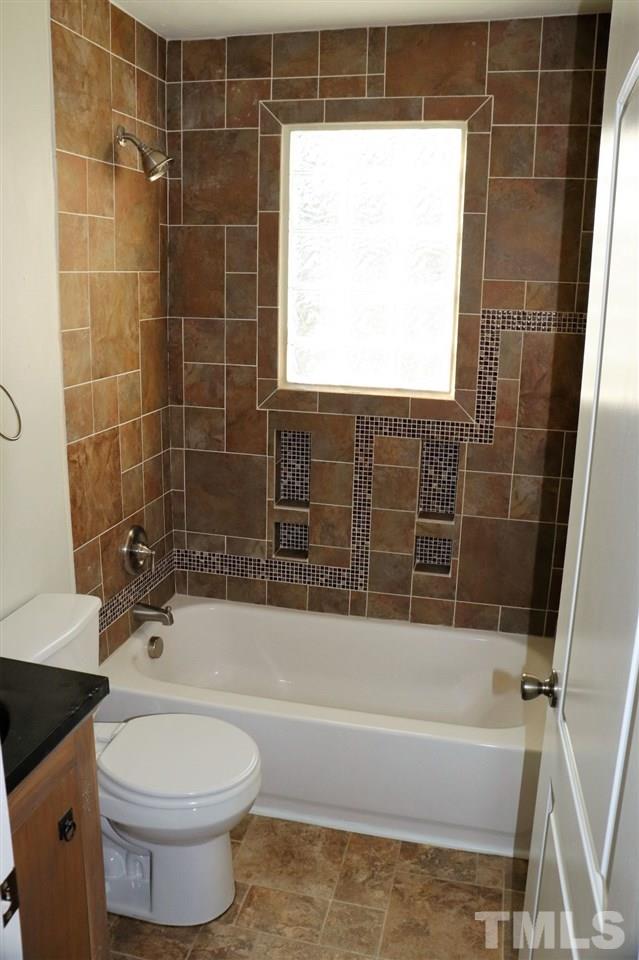 2110 Tudor Place Raleigh, NC 27610 - Photo 10 of 17 a bathroom with a toilet a sink and bathtub