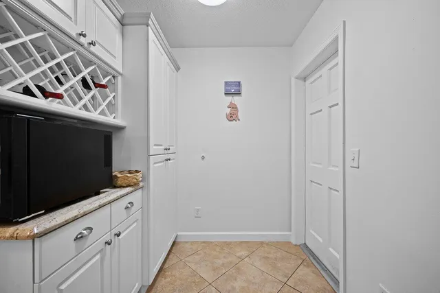 a view of a kitchen with microwave and cabinets