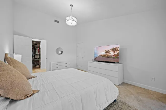 a bedroom with a bed and a painting on the wall