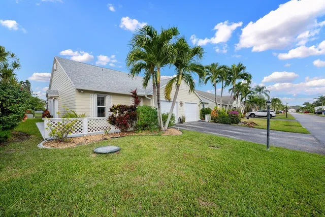 a view of a house with swimming pool and a yard