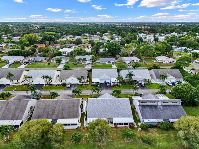 an aerial view of multiple houses with yard