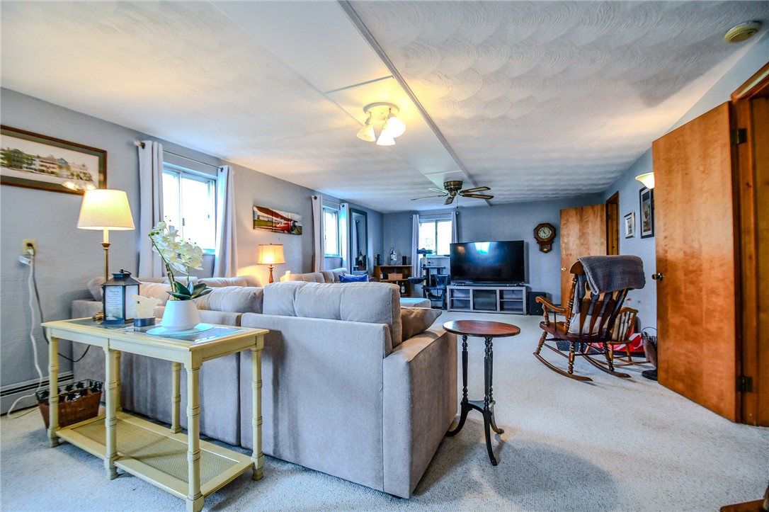 10833 Kendig Road Medway, OH 45341 - Photo 30 of 46 This inviting living room features a bright ambiance and comfortable spaces for relaxation and entertainment.