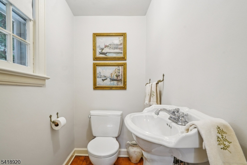 66 Springbrook Road Springfield, NJ 07081 - Photo 22 of 38 a bathroom with a toilet sink and mirror
