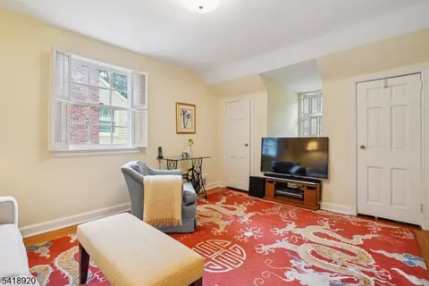 a living room with a flat screen tv and a window
