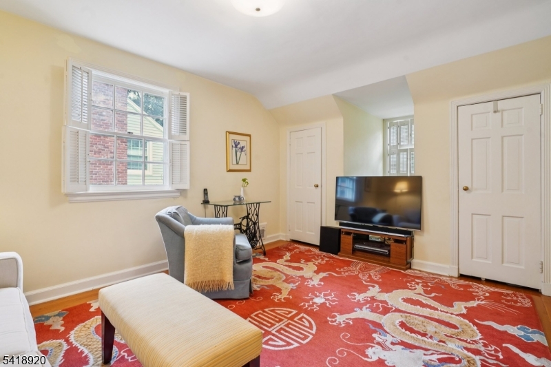 66 Springbrook Road Springfield, NJ 07081 - Photo 28 of 38 a living room with a flat screen tv and a window